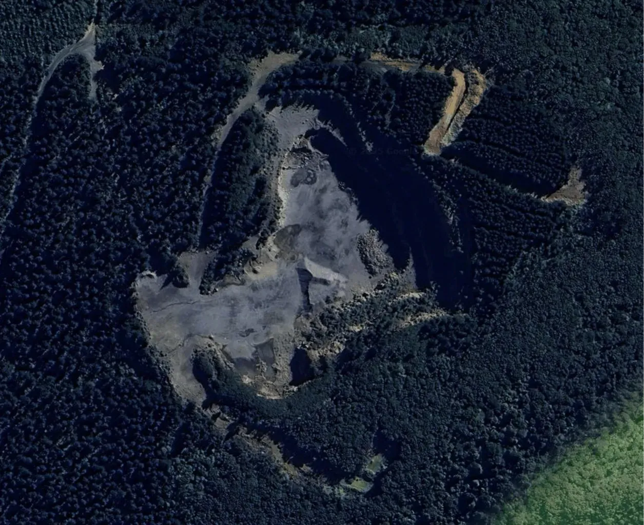 Aerial view of Blackhead Quarries’ Mt Kettle site, showing the quarry pit surrounded by dense forest.